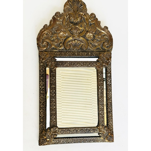 109 - WALL MIRRORS, a near pair, late/early 20th century Dutch style repoussé silvered, each with cushion ... 