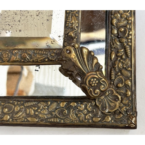 109 - WALL MIRRORS, a near pair, late/early 20th century Dutch style repoussé silvered, each with cushion ... 