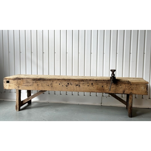 129 - WORK BENCH/TABLE, early 20th century exceptionally long planked pine with enclosed ends, 317cm W x 7... 