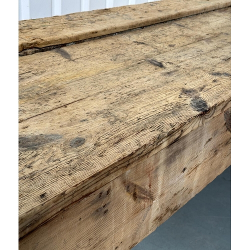 129 - WORK BENCH/TABLE, early 20th century exceptionally long planked pine with enclosed ends, 317cm W x 7... 