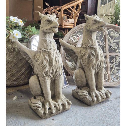 457 - SCULPTURAL GRIFFINS, a pair, composite stone, 77cm H. (2)