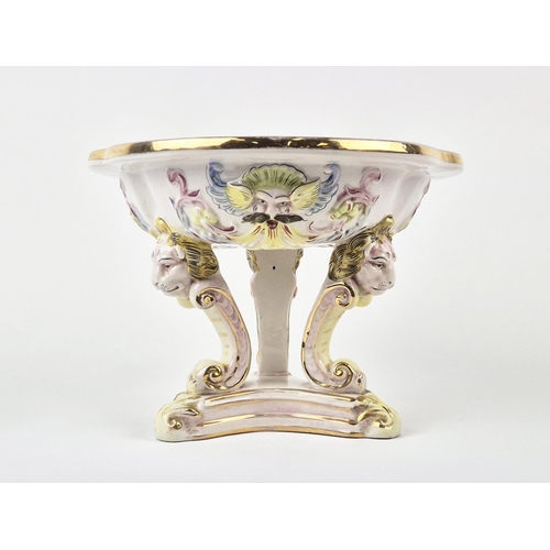 7 - CAPODIMONTE TAZZA, mid century, shaped gilt edge top with mask adorned body on tri-form lion head C-... 