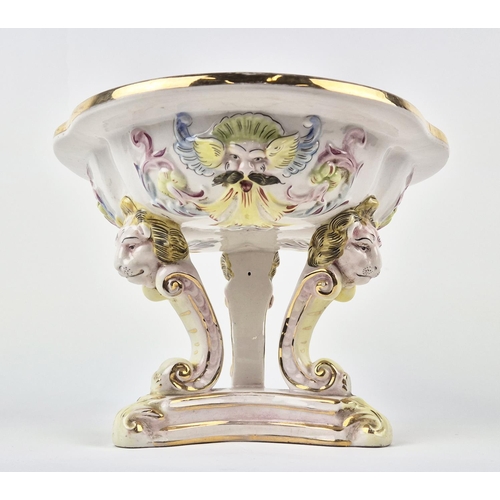 7 - CAPODIMONTE TAZZA, mid century, shaped gilt edge top with mask adorned body on tri-form lion head C-... 