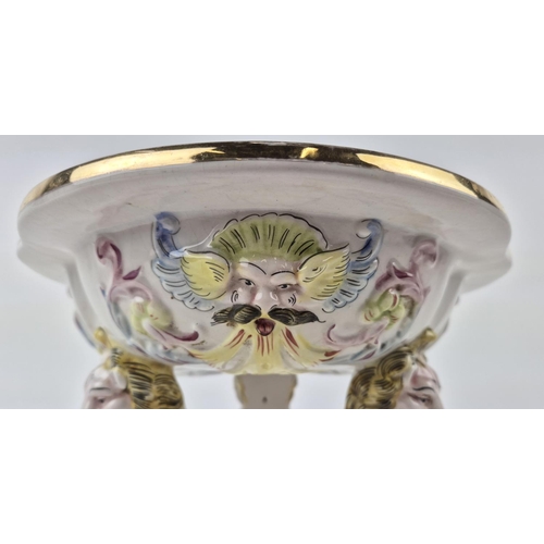 7 - CAPODIMONTE TAZZA, mid century, shaped gilt edge top with mask adorned body on tri-form lion head C-... 