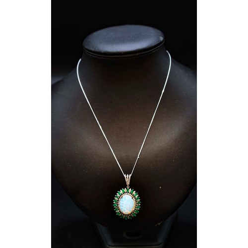 21 - SILVER PENDANT SET WITH A LARGE OVAL CABOCHON OPAL, rose-cut diamonds and marquise-cut emeralds on a... 