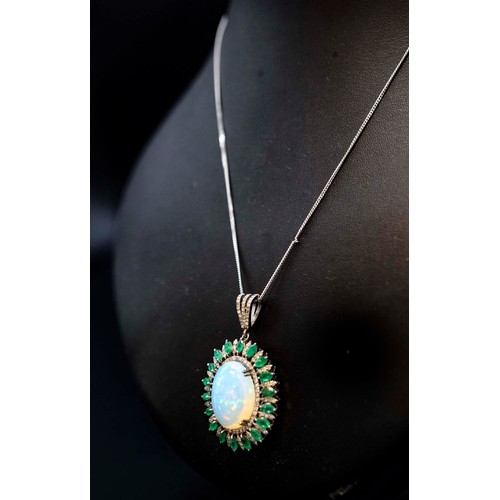 21 - SILVER PENDANT SET WITH A LARGE OVAL CABOCHON OPAL, rose-cut diamonds and marquise-cut emeralds on a... 