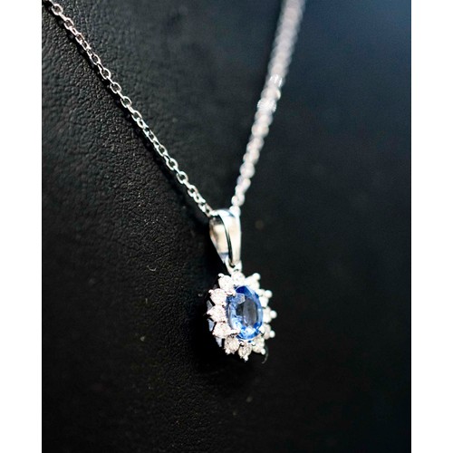 29 - 18CT WHITE GOLD OVAL CORNFLOWER BLUE SAPPHIRE AND RBC DIAMOND PENDANT, on an 18ct white gold chain b... 