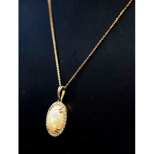 30 - 9CT YELLOW GOLD OVAL CABOCHON OPAL AND RBC DIAMOND CLUSTER PENDANT with twin prong settings, on a 9c... 