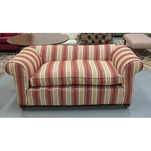 141 - CHESTERFIELD SOFA, early 20th century in terracotta and cream striped upholstery on brass castors, 7... 