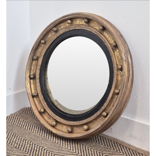 121 - CONVEX WALL MIRROR, early 19th century Regency period giltwood, the convex plate with ebonised slip ... 