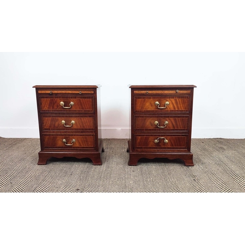 179 - BEDSIDE CHESTS, a pair, Georgian style crossbanded mahogany, each with brushing slide above three dr... 