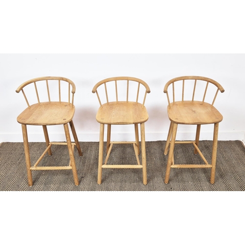 409 - BAR STOOLS, a set of three, light oak with spindle backs, 90cm H x 45cm W x 41cm D. (3)