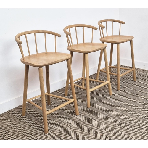 409 - BAR STOOLS, a set of three, light oak with spindle backs, 90cm H x 45cm W x 41cm D. (3)