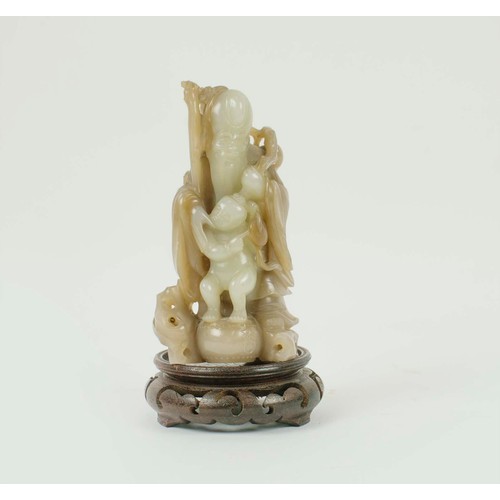 2 - A CHINESE JADE SHOU LAO CARVING, 18th/19th century, with peach vine and boy standing on vessel point... 