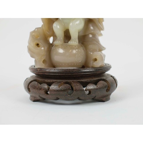 2 - A CHINESE JADE SHOU LAO CARVING, 18th/19th century, with peach vine and boy standing on vessel point... 