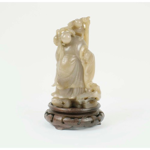 2 - A CHINESE JADE SHOU LAO CARVING, 18th/19th century, with peach vine and boy standing on vessel point... 