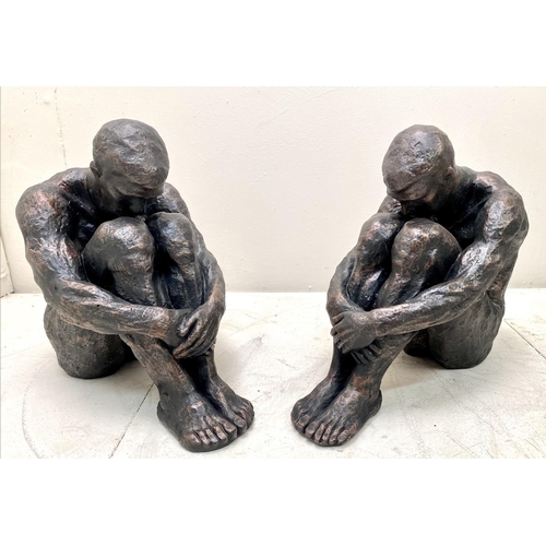 385 - SITTING MAN SCULPTURES, a pair, 34cm H x 21cm x 40cm. (2)