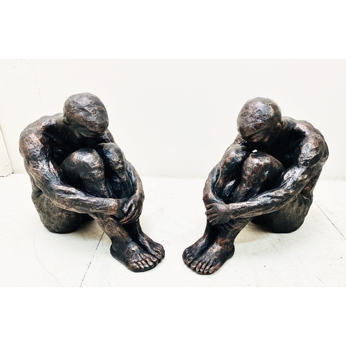 385 - SITTING MAN SCULPTURES, a pair, 34cm H x 21cm x 40cm. (2)