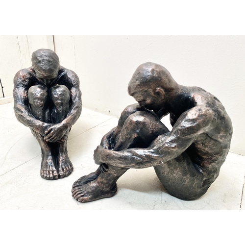 385 - SITTING MAN SCULPTURES, a pair, 34cm H x 21cm x 40cm. (2)