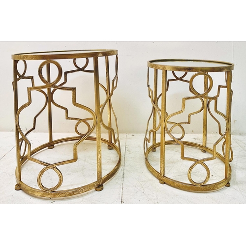 388 - SIDE TABLES, a graduated set of two, gilt metal with circular mirrored tops, larger 56cm H x 46cm. (... 