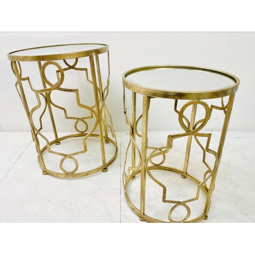 388 - SIDE TABLES, a graduated set of two, gilt metal with circular mirrored tops, larger 56cm H x 46cm. (... 