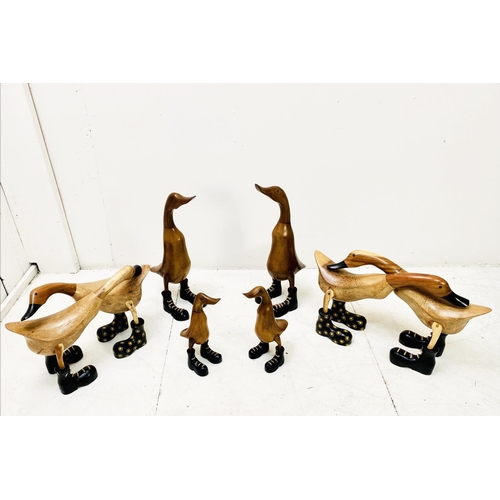 389 - WOODEN DUCKS, a collection, various poses, wearing boots. (6 individual pieces/8 ducks) Largest 44cm... 