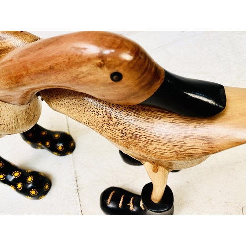 389 - WOODEN DUCKS, a collection, various poses, wearing boots. (6 individual pieces/8 ducks) Largest 44cm... 