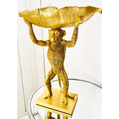 384 - MONKEY TAZZAS, a set of four, gilt resin each with palm leaf dishes, 35cm H x 28cm x 11cm. (4)