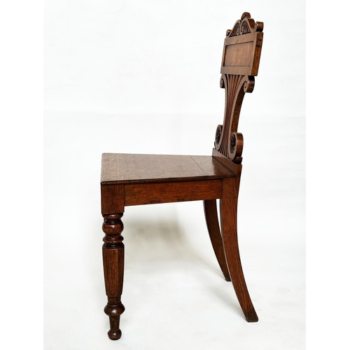 177 - HALL CHAIRS, a pair, late Regency oak each with scroll back, panel seat and facetted front supports,... 