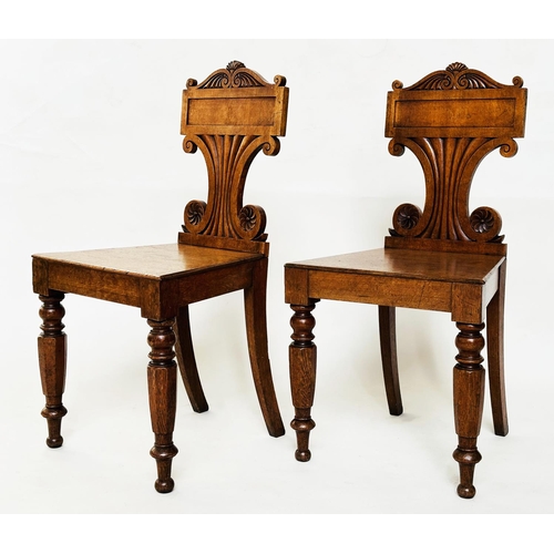 177 - HALL CHAIRS, a pair, late Regency oak each with scroll back, panel seat and facetted front supports,... 