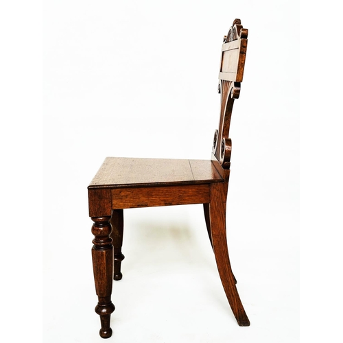 177 - HALL CHAIRS, a pair, late Regency oak each with scroll back, panel seat and facetted front supports,... 