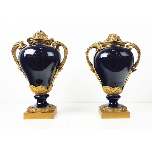 18 - ORMOLU MOUNTED VASES, a pair, Louis XV style, cobalt blue porcelain with rococo style ormolu mounts ... 