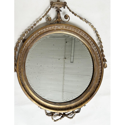 183 - ADAM STYLE MIRROR, early 20th century Robert Adam style giltwood and gesso, circular with bell husk ... 