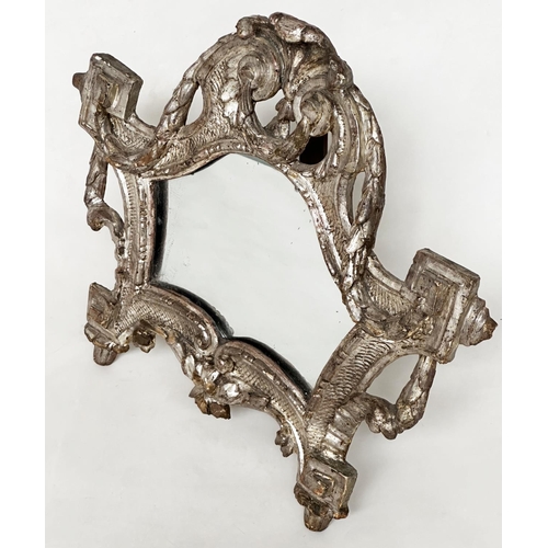 185 - TOILET MIRROR, 18th century Italian silvered and carved wood, rectangular with scroll frame and ease... 