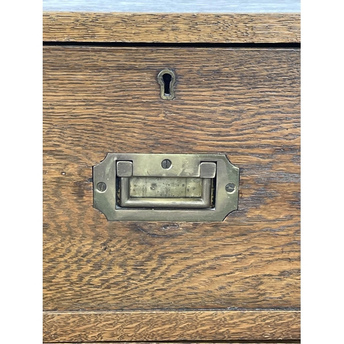 278 - CAMPAIGN CHEST, early 20th century oak, having two short and three long drawers with brass recessed ... 