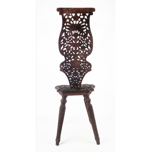 373 - MILKING CHAIR, early 20th century Indian hardwood and all over carved, 76cm H x 31cm W.