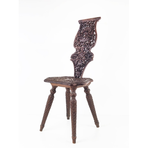 373 - MILKING CHAIR, early 20th century Indian hardwood and all over carved, 76cm H x 31cm W.