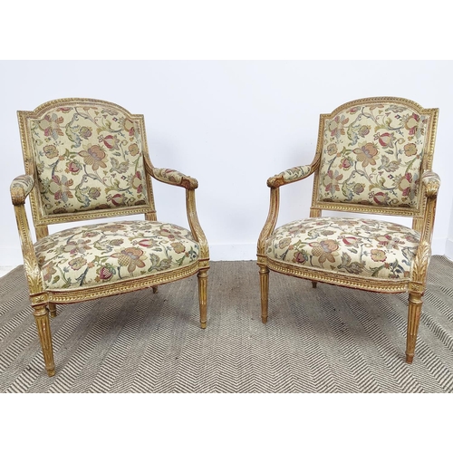 553 - FAUTEUILS, a pair, Napoleon III giltwood with floral patterned upholstery, 101cm H x 67cm W. (2)