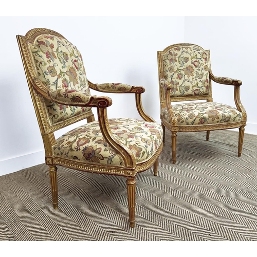 553 - FAUTEUILS, a pair, Napoleon III giltwood with floral patterned upholstery, 101cm H x 67cm W. (2)