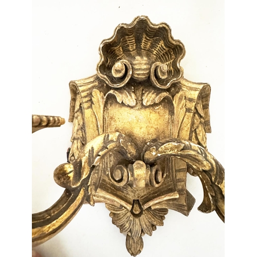 570 - WALL LIGHTS, a pair, carved giltwood each with bow crest and two branch candelabra, together with a ... 