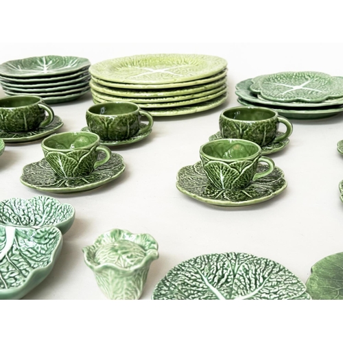 571 - GREEN MAJOLICA WARE, a large quantity Italian, English, French and Portuguese, green majolica. (Qty)