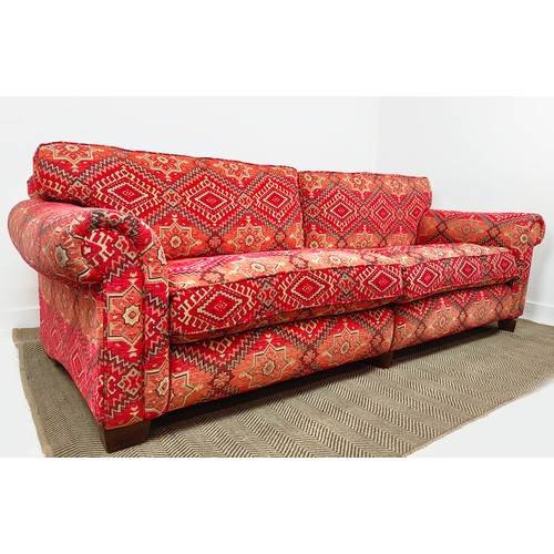 614 - MODULAR SOFA, two parts, in red kilim patterned chenille, 98cm H x 226cm W x 114cm D overall.