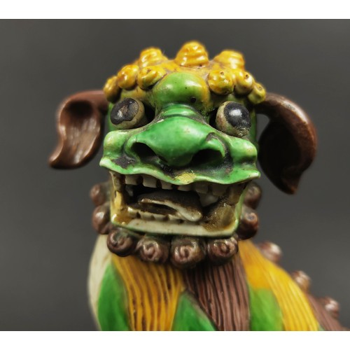 26 - CHINESE SANCAI GLAZED KANGXI BUDDHIST LIONS, a pair, incense holders with loose ears, eyes and ball ... 