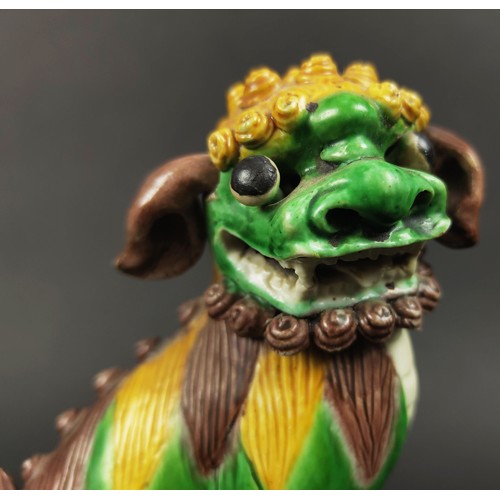 26 - CHINESE SANCAI GLAZED KANGXI BUDDHIST LIONS, a pair, incense holders with loose ears, eyes and ball ... 