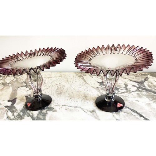 67 - MURANO GLASS TAZZE, a pair, ruffle rimmed circa 1950, clear and aubergine on pierced stem and spread... 