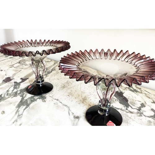 67 - MURANO GLASS TAZZE, a pair, ruffle rimmed circa 1950, clear and aubergine on pierced stem and spread... 