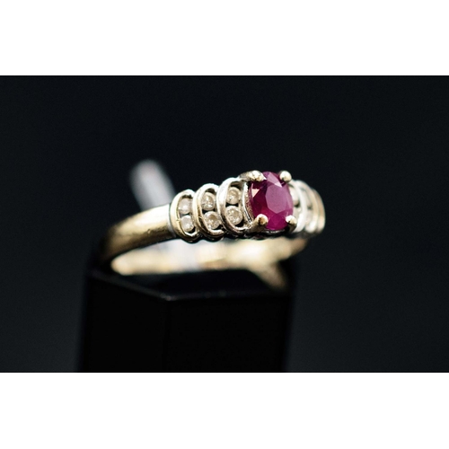 135 - AN 18CT WHITE GOLD ART DECO STYLE RUBY AND DIAMOND SET DRESS RING, the central mixed cut ruby flanke... 