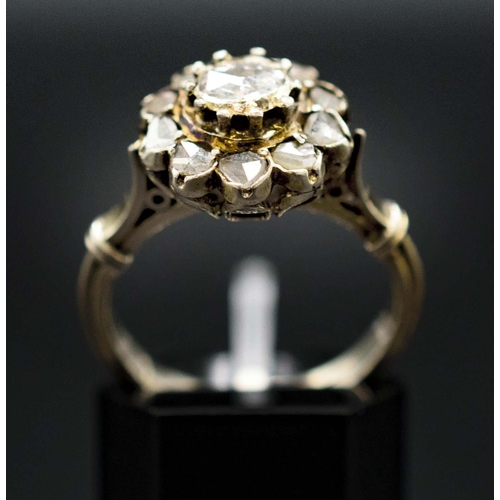 136 - A YELLOW METAL DIAMOND CLUSTER RING, probably 18th century, set with a central rose cut stone of app... 