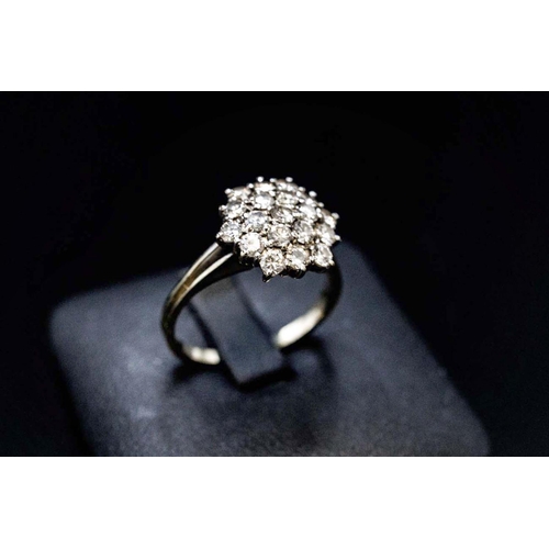 144 - AN 18CT WHITE GOLD DIAMOND CLUSTER RING, the setting with nineteen round brilliant cut diamonds, wit... 