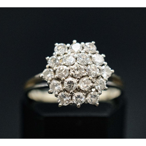 144 - AN 18CT WHITE GOLD DIAMOND CLUSTER RING, the setting with nineteen round brilliant cut diamonds, wit... 